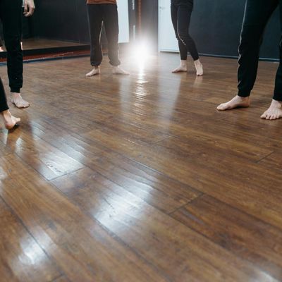 Feet balancing on a wooden surface during exercise session